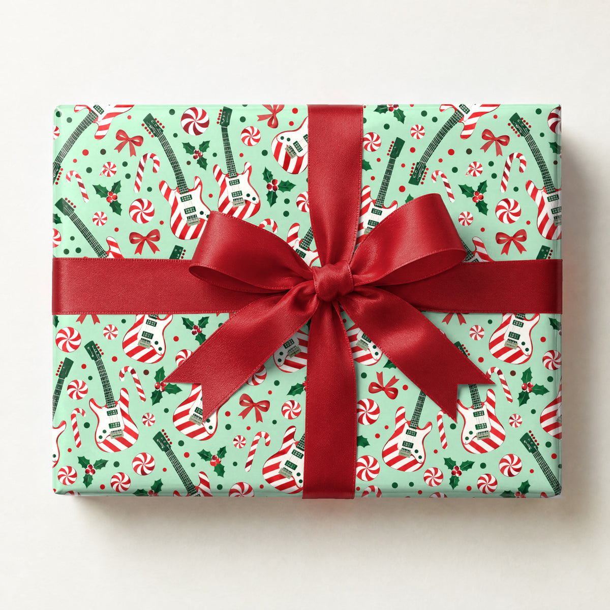 Candy Cane Guitars Wrapping Paper, a gift box wrapped in it and tied with a satin ribbon