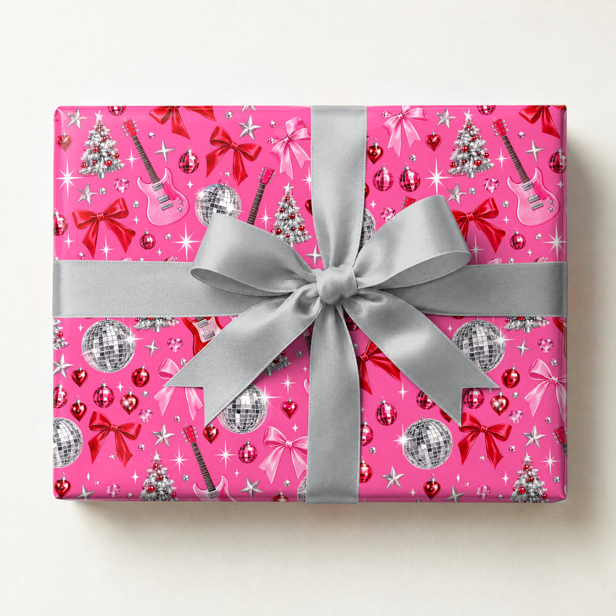 Pinkmas Disco Wrapping Paper, a gift box wrapped in it and tied with a satin ribbon