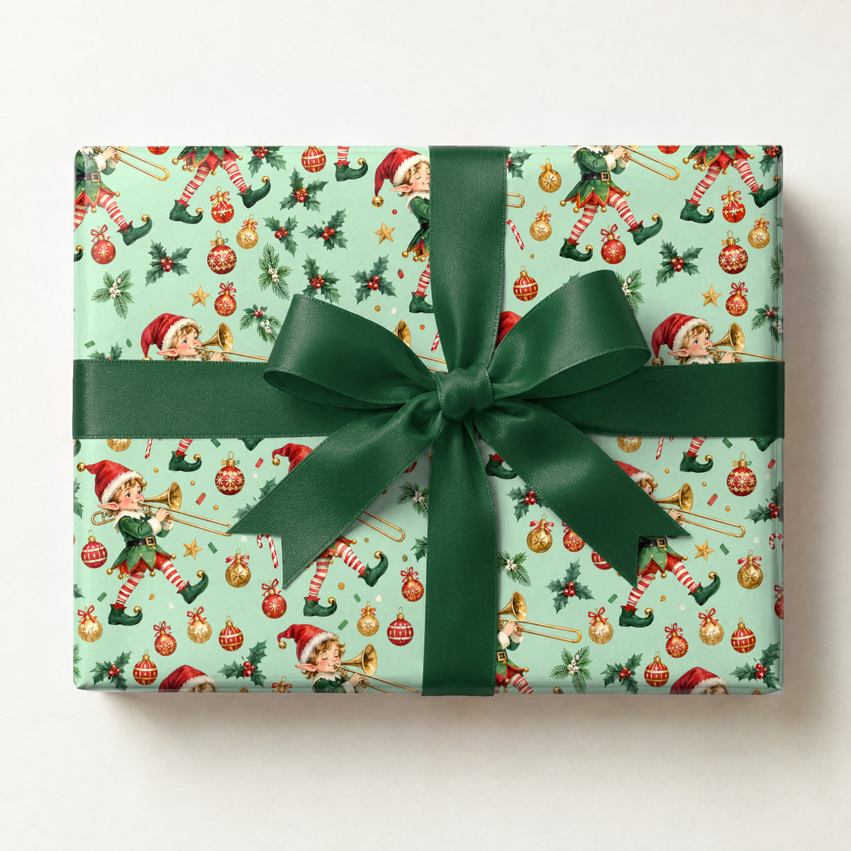 Elf Trombone Parade Wrapping Paper, a gift box wrapped in it and tied with a satin ribbon
