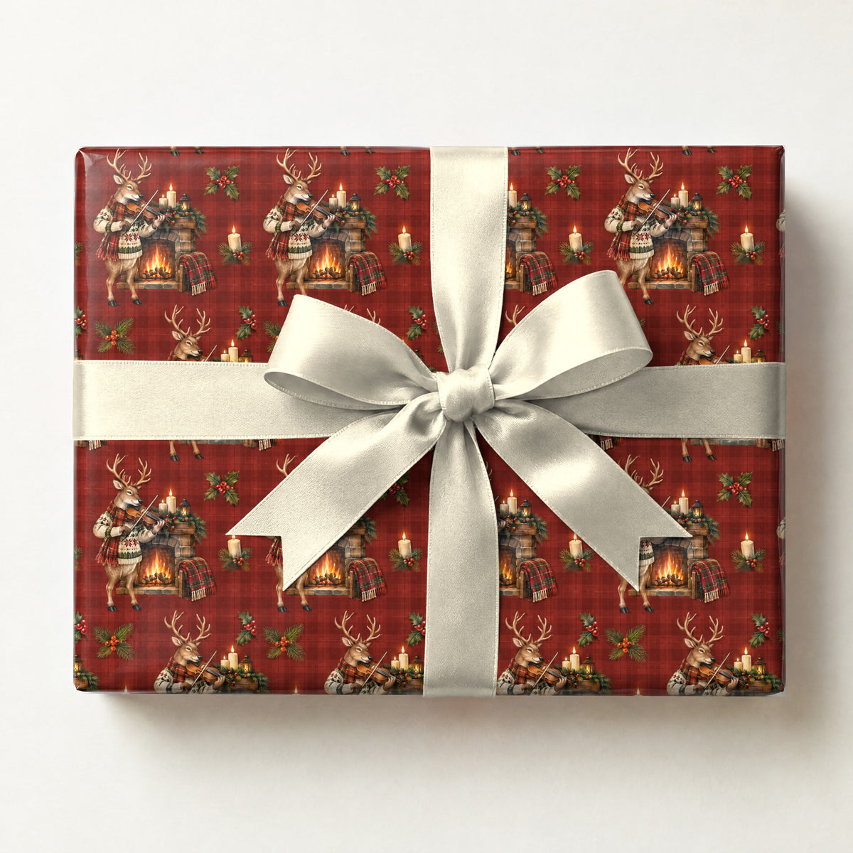 Reindeer Fiddle Fireside Wrapping Paper, a gift box wrapped in it and tied with a satin ribbon