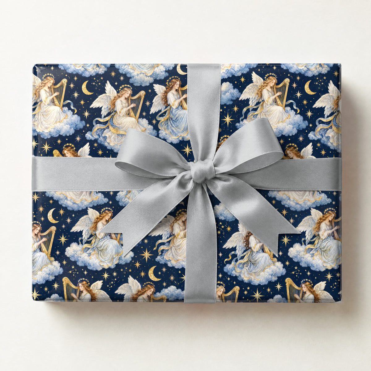 Angel Harp Starlight Wrapping Paper, a gift box wrapped in it and tied with a satin ribbon