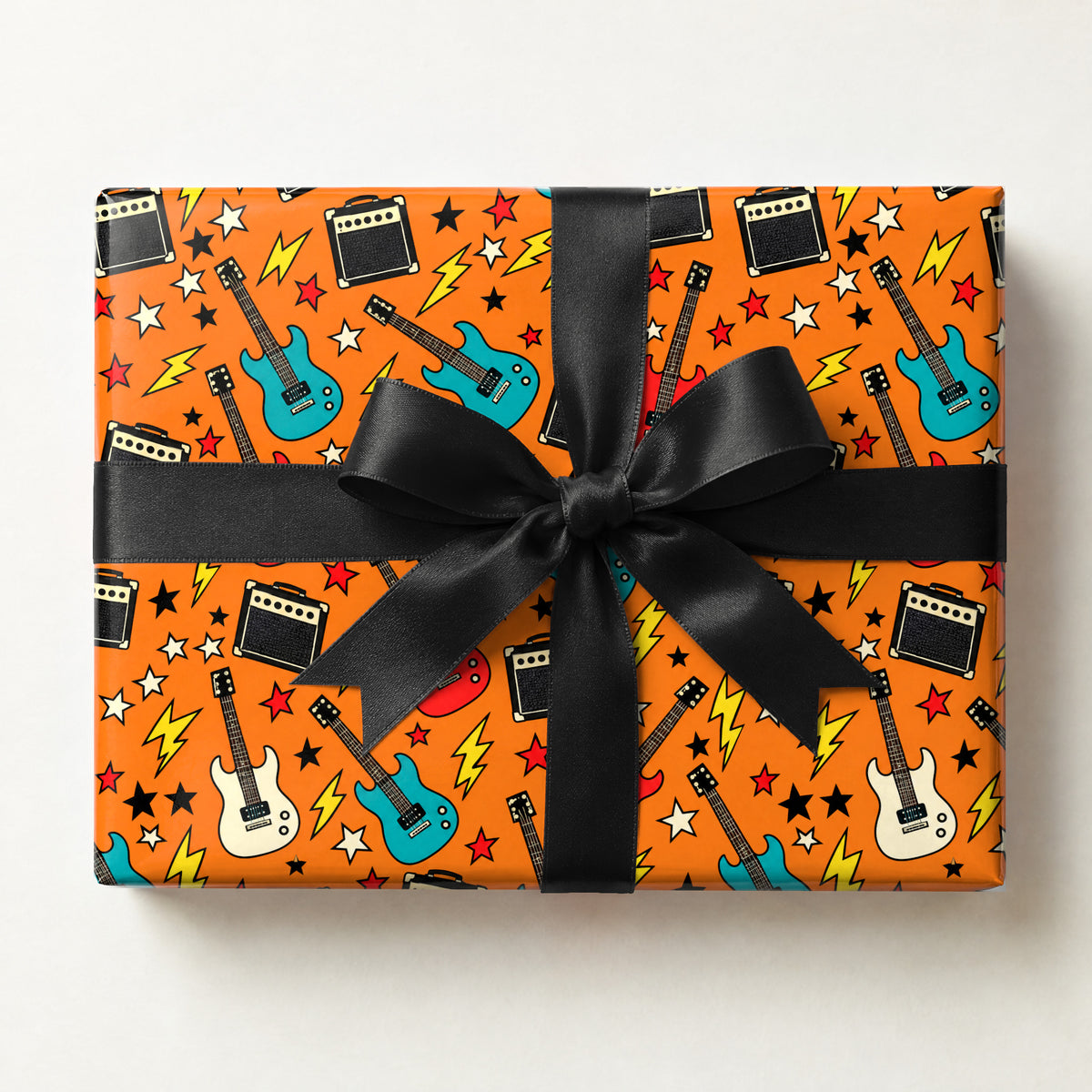 Guitar and Amp Rock Wrapping Paper, a gift box wrapped in it and tied with a satin ribbon
