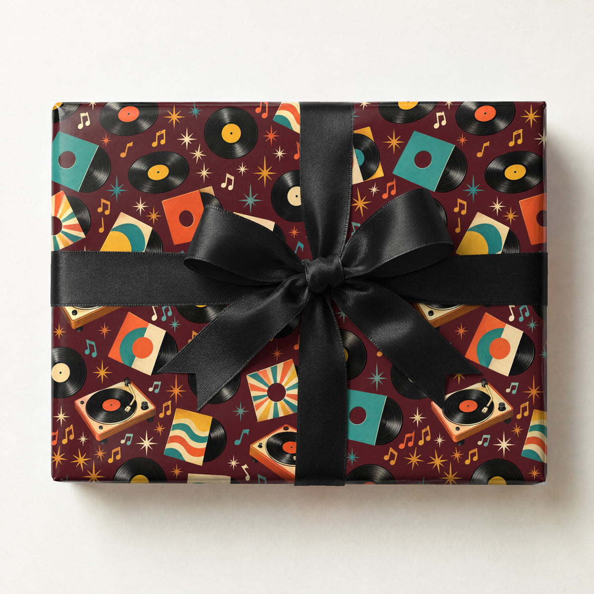 Vinyl Record Collage Wrapping Paper, a gift box wrapped in it and tied with a satin ribbon