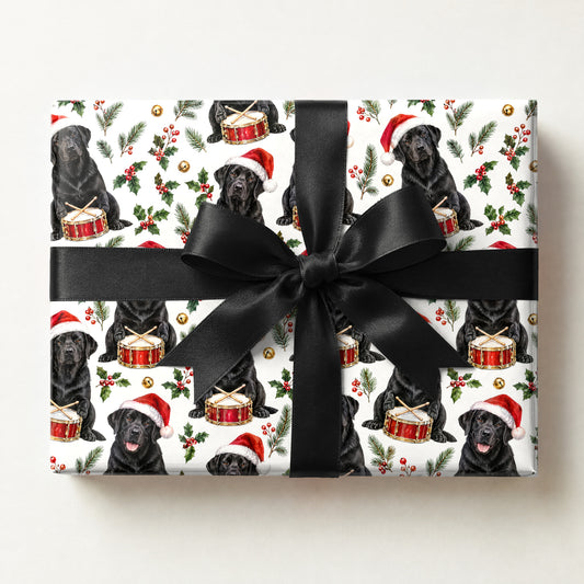 Black Lab Santa Drummer Wrapping Paper, a gift box wrapped in it and tied with a satin ribbon
