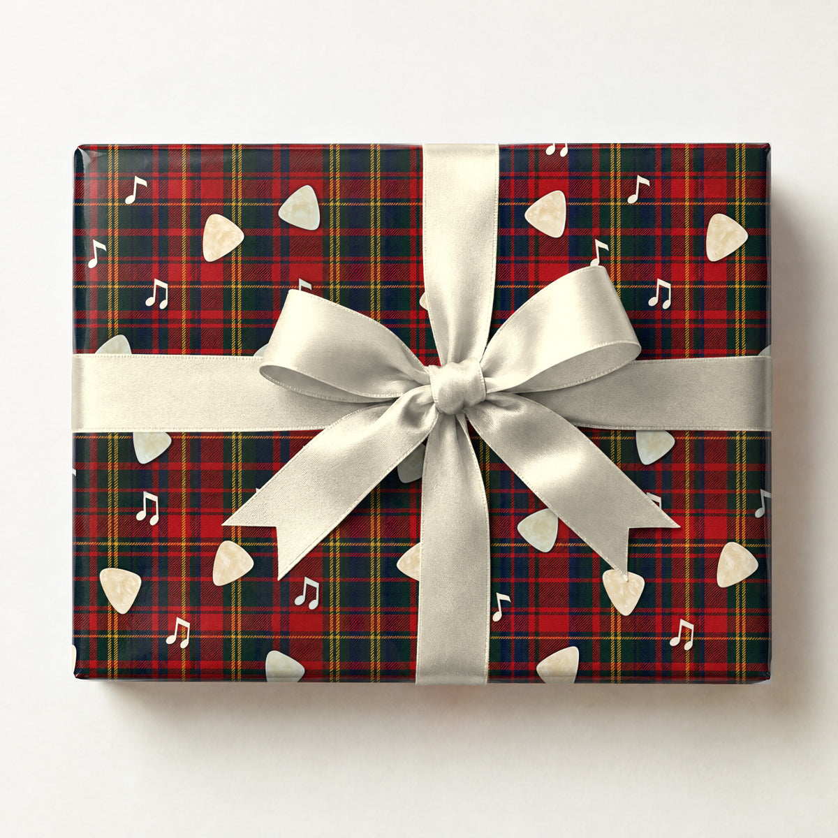 Rock and Roll Tartan Wrapping Paper, a gift box wrapped in it and tied with a satin ribbon
