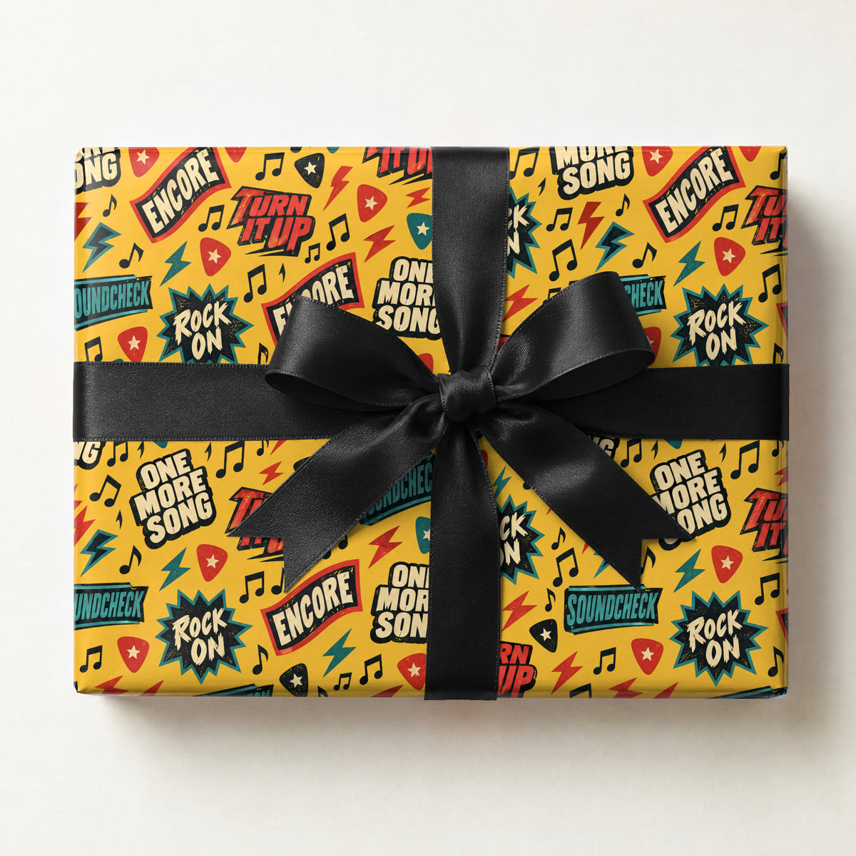 Musician Sayings Wrapping Paper, a gift box wrapped in it and tied with a satin ribbon