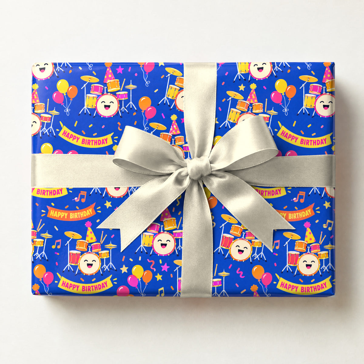 Birthday Drum Confetti Wrapping Paper, a gift box wrapped in it and tied with a satin ribbon