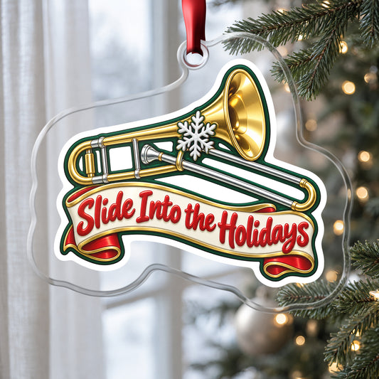 Slide Into the Holidays Trombone clear acrylic Christmas ornament hanging on a Christmas tree by a window in soft daylight