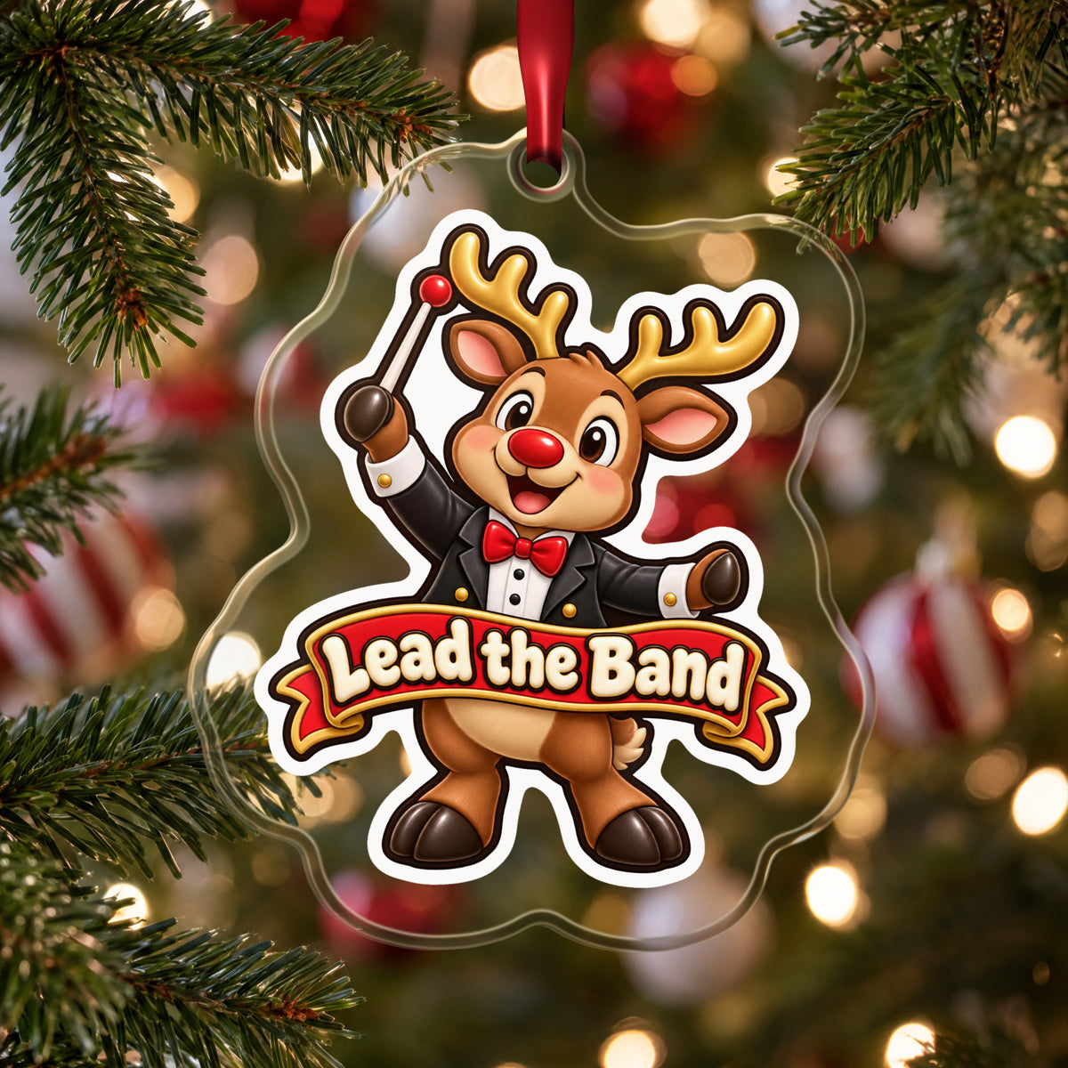 Lead the Band Reindeer Conductor clear acrylic Christmas ornament hanging on a Christmas tree with red and white baubles