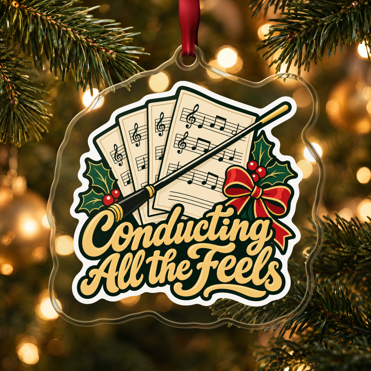 Conducting All the Feels Baton clear acrylic Christmas ornament hanging on a lit Christmas tree with warm gold lights