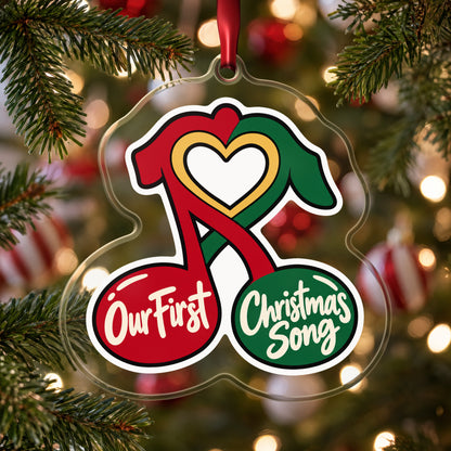 Our First Christmas Song Music Notes clear acrylic Christmas ornament hanging on a Christmas tree with red and white baubles