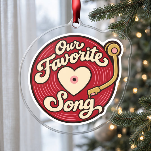 Our Favorite Song Vinyl Record clear acrylic Christmas ornament hanging on a Christmas tree by a window in soft daylight