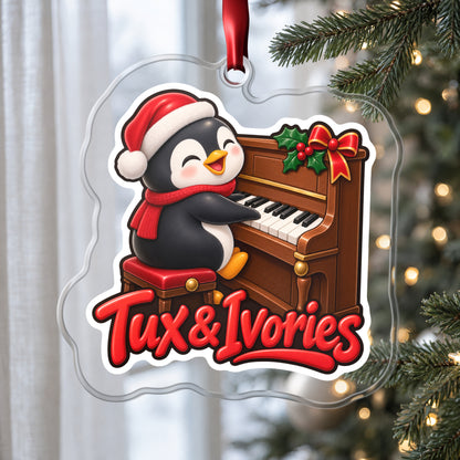Tux & Ivories Penguin Piano clear acrylic Christmas ornament hanging on a Christmas tree by a window in soft daylight