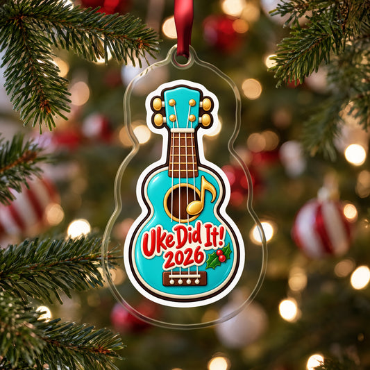 Uke Did It 2026 First Ukulele clear acrylic Christmas ornament hanging on a Christmas tree with red and white baubles