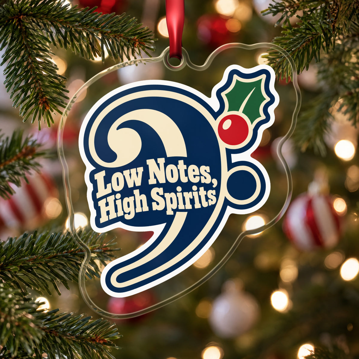 Low Notes, High Spirits Bass Clef clear acrylic Christmas ornament hanging on a Christmas tree with red and white baubles