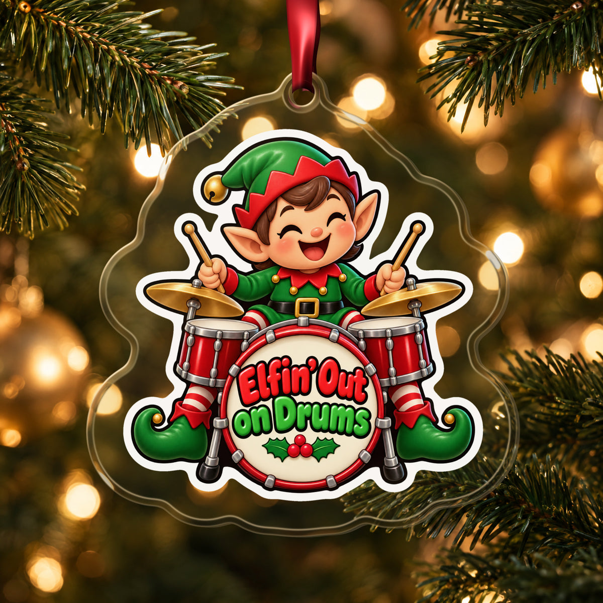 Elfin' Out on Drums Elf Drummer clear acrylic Christmas ornament hanging on a lit Christmas tree with warm gold lights