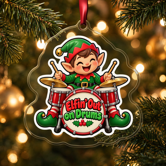 Elfin' Out on Drums Elf Drummer clear acrylic Christmas ornament hanging on a lit Christmas tree with warm gold lights