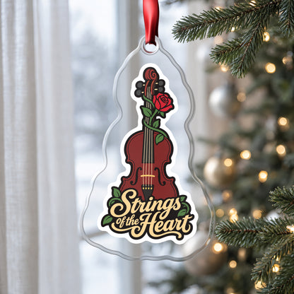 Strings of the Heart Violin clear acrylic Christmas ornament hanging on a Christmas tree by a window in soft daylight