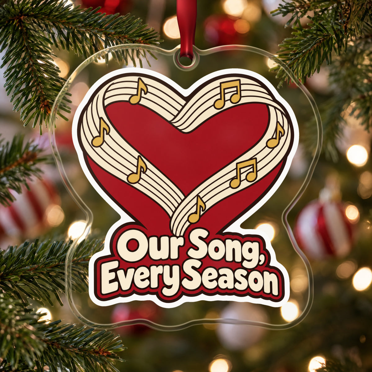 Our Song, Every Season Sheet Music Heart clear acrylic Christmas ornament hanging on a Christmas tree with red and white baubles