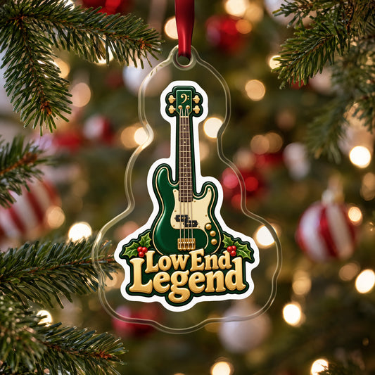Low End Legend Bass Guitar clear acrylic Christmas ornament hanging on a Christmas tree with red and white baubles