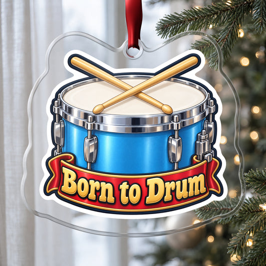 Born to Drum Snare Drum clear acrylic Christmas ornament hanging on a Christmas tree by a window in soft daylight