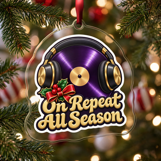 On Repeat Vinyl and Headphones clear acrylic Christmas ornament hanging on a Christmas tree with red and white baubles