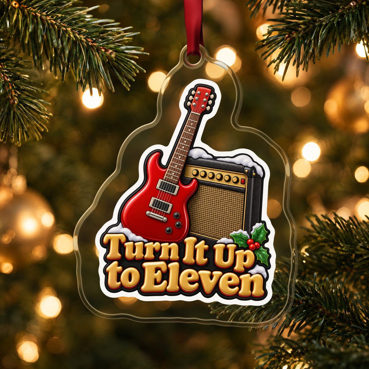 Turn It Up to Eleven Guitar and Amp clear acrylic Christmas ornament hanging on a lit Christmas tree with warm gold lights
