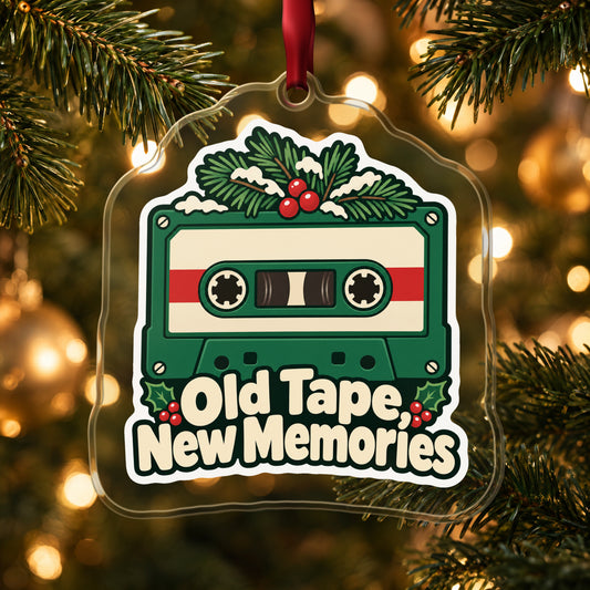 Old Tape, New Memories Cassette clear acrylic Christmas ornament hanging on a lit Christmas tree with warm gold lights