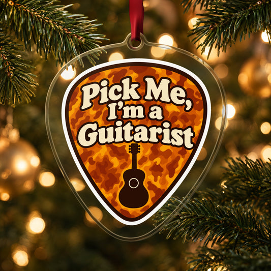 Pick Me, I'm a Guitarist Guitar Pick clear acrylic Christmas ornament hanging on a lit Christmas tree with warm gold lights