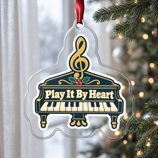 Play It By Heart Grand Piano clear acrylic Christmas ornament hanging on a Christmas tree by a window in soft daylight