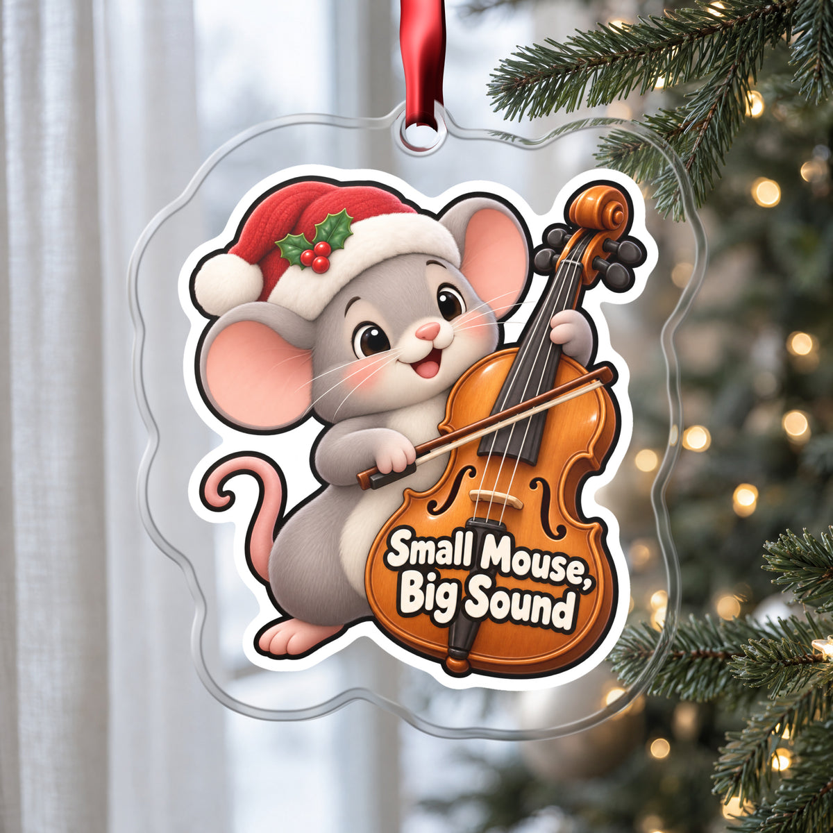 Small Mouse, Big Sound Cello clear acrylic Christmas ornament hanging on a Christmas tree by a window in soft daylight