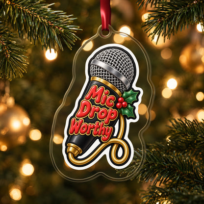 Mic Drop Worthy Microphone clear acrylic Christmas ornament hanging on a lit Christmas tree with warm gold lights