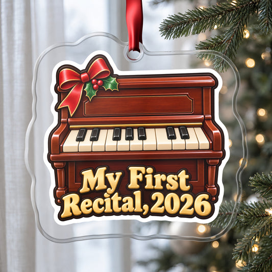 My First Piano Recital 2026 clear acrylic Christmas ornament hanging on a Christmas tree by a window in soft daylight