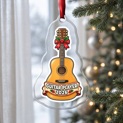 Guitar Player 2026 clear acrylic Christmas ornament hanging on a Christmas tree by a window in soft daylight