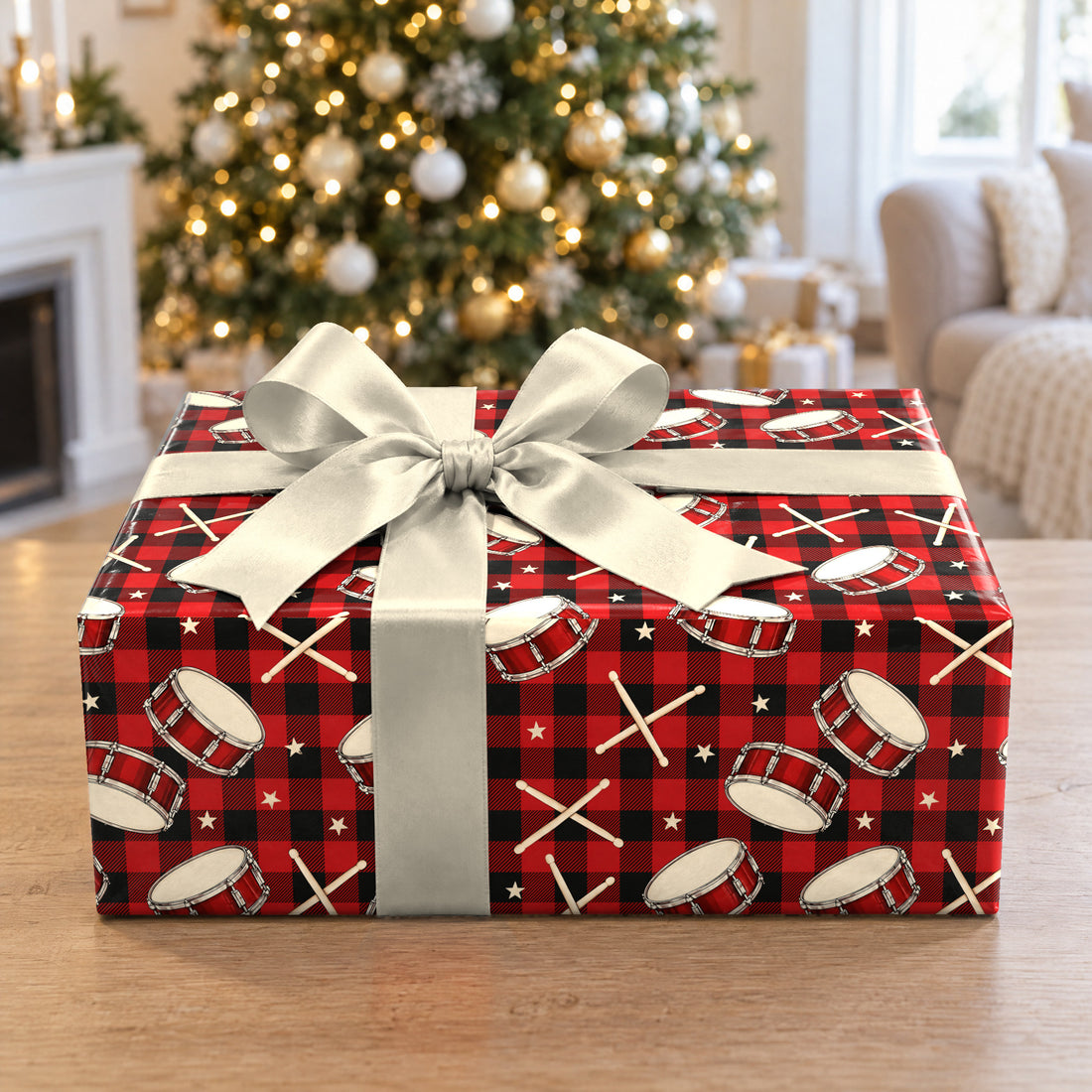 A gift wrapped in Buffalo Plaid Drumsticks Wrapping Paper in front of a Christmas tree