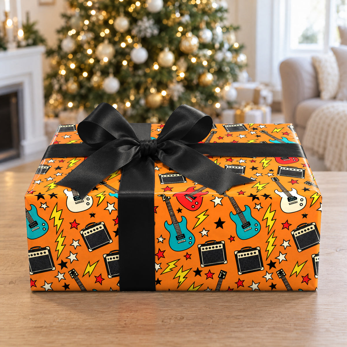 A gift wrapped in Guitar and Amp Rock Wrapping Paper in front of a Christmas tree