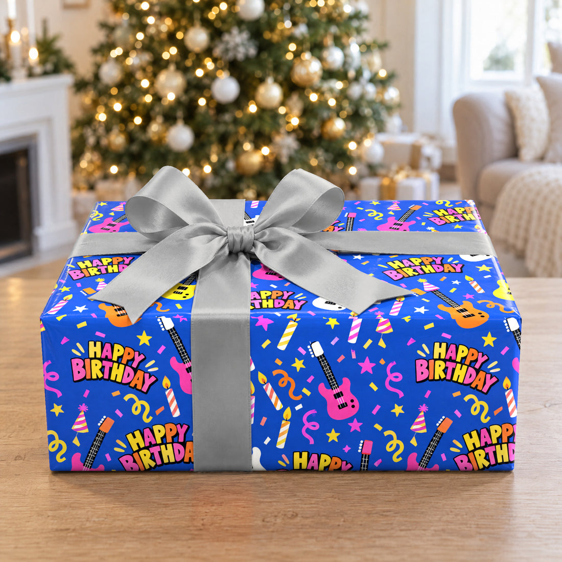 A gift wrapped in Happy Birthday Rock Star Wrapping Paper in front of a Christmas tree