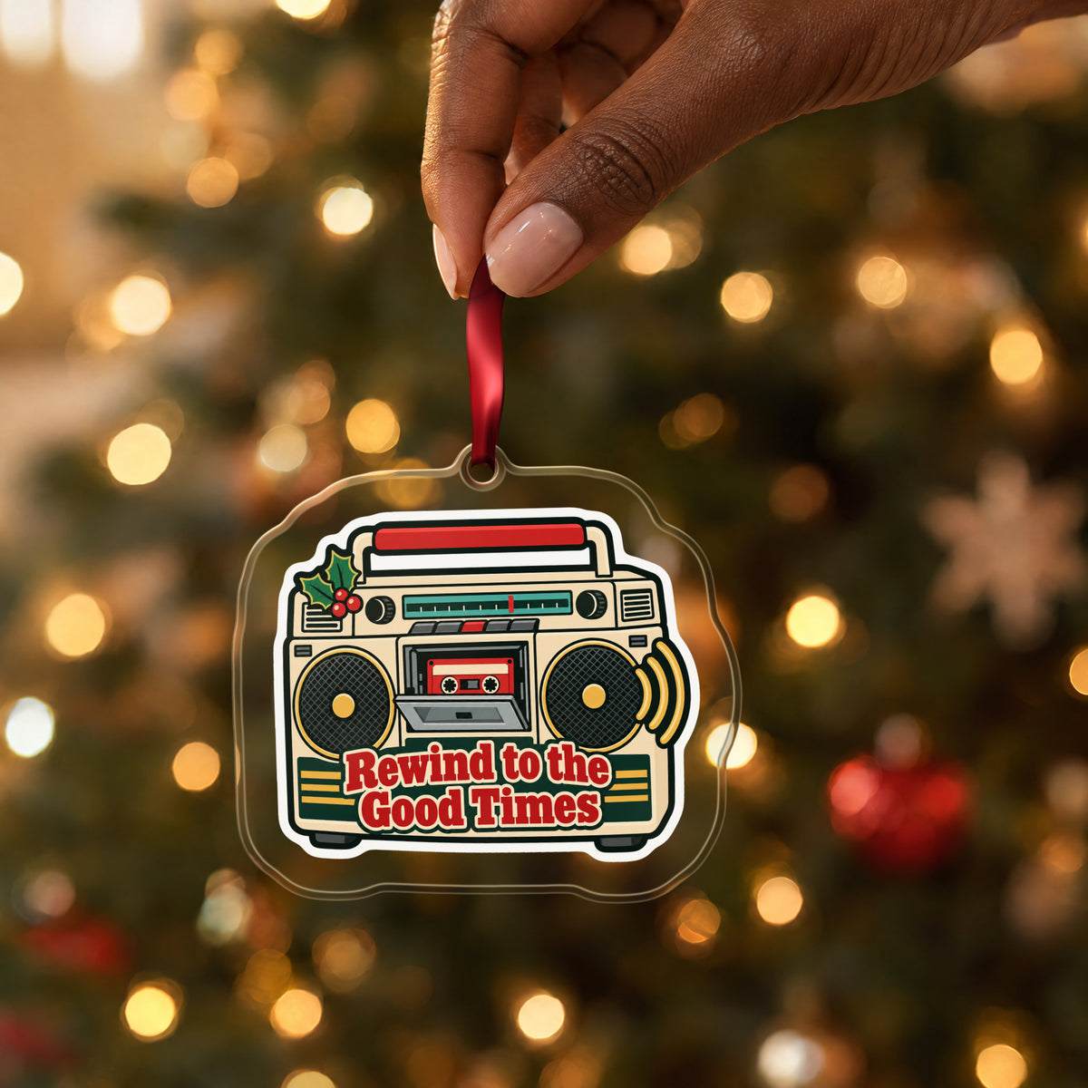 Rewind to the Good Times Boombox clear acrylic Christmas ornament held by its red ribbon in a hand, shown at its real size