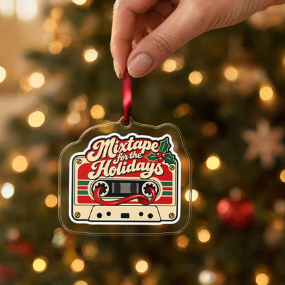 Mixtape for the Holidays Cassette clear acrylic Christmas ornament held by its red ribbon in a hand, shown at its real size