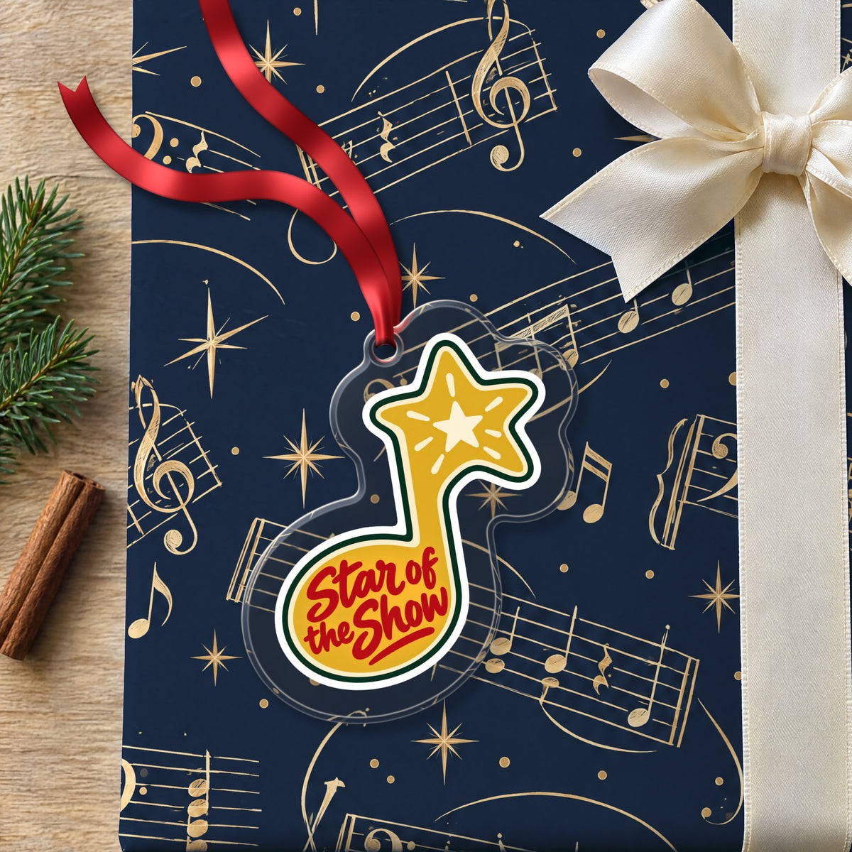 Star of the Show Music Note clear acrylic Christmas ornament lying on a gift wrapped in Rhythm and Beat music wrapping paper