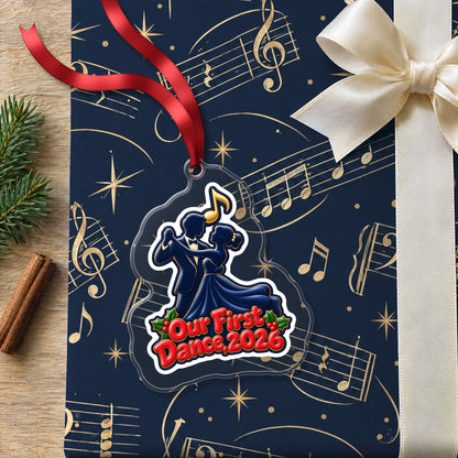 Our First Dance 2026 Couple clear acrylic Christmas ornament lying on a gift wrapped in Rhythm and Beat music wrapping paper