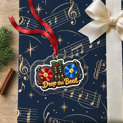 Drop the Beat DJ Turntables clear acrylic Christmas ornament lying on a gift wrapped in Rhythm and Beat music wrapping paper