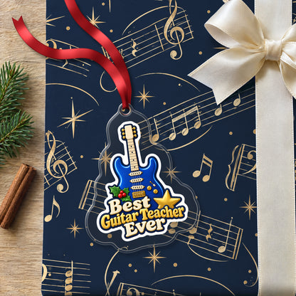 Best Guitar Teacher Ever clear acrylic Christmas ornament lying on a gift wrapped in Rhythm and Beat music wrapping paper