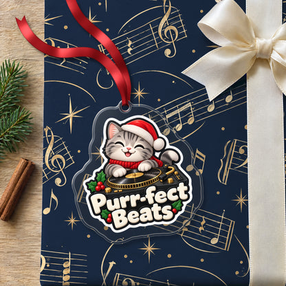 Purr-fect Beats Cat DJ clear acrylic Christmas ornament lying on a gift wrapped in Rhythm and Beat music wrapping paper