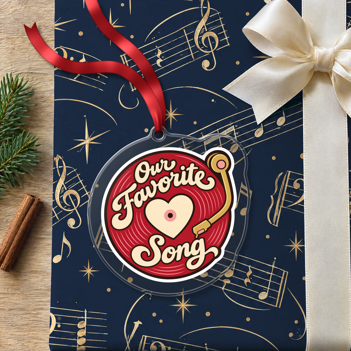 Our Favorite Song Vinyl Record clear acrylic Christmas ornament lying on a gift wrapped in Rhythm and Beat music wrapping paper