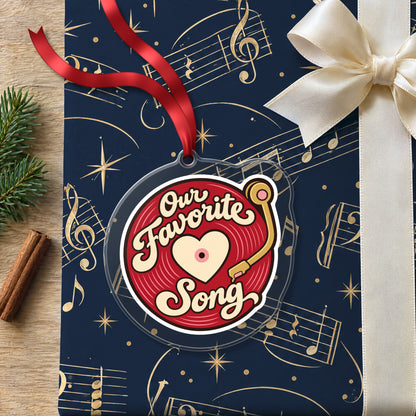Our Favorite Song Vinyl Record clear acrylic Christmas ornament lying on a gift wrapped in Rhythm and Beat music wrapping paper