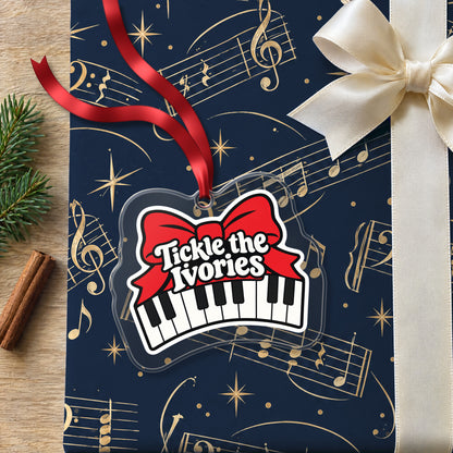 Tickle the Ivories Piano Keys clear acrylic Christmas ornament lying on a gift wrapped in Rhythm and Beat music wrapping paper