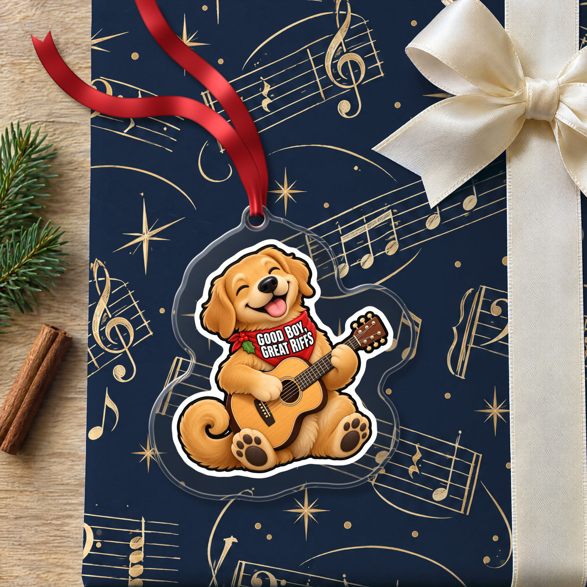 Good Boy, Great Riffs Dog Guitar clear acrylic Christmas ornament lying on a gift wrapped in Rhythm and Beat music wrapping paper