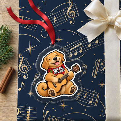 Good Boy, Great Riffs Dog Guitar clear acrylic Christmas ornament lying on a gift wrapped in Rhythm and Beat music wrapping paper