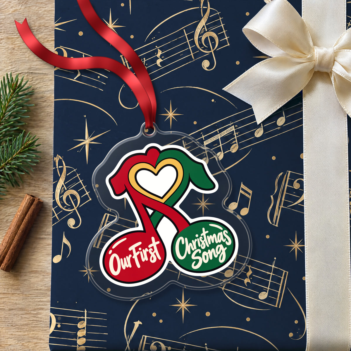 Our First Christmas Song Music Notes clear acrylic Christmas ornament lying on a gift wrapped in Rhythm and Beat music wrapping paper